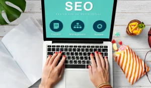 Gambar tangan sedang mengetik di depan laptop modern dengan tampilan layar bertuliskan SEO, desain profesional, clean workspace, nuansa digital marketing, pencahayaan terang dan estetik - Mentor Juara